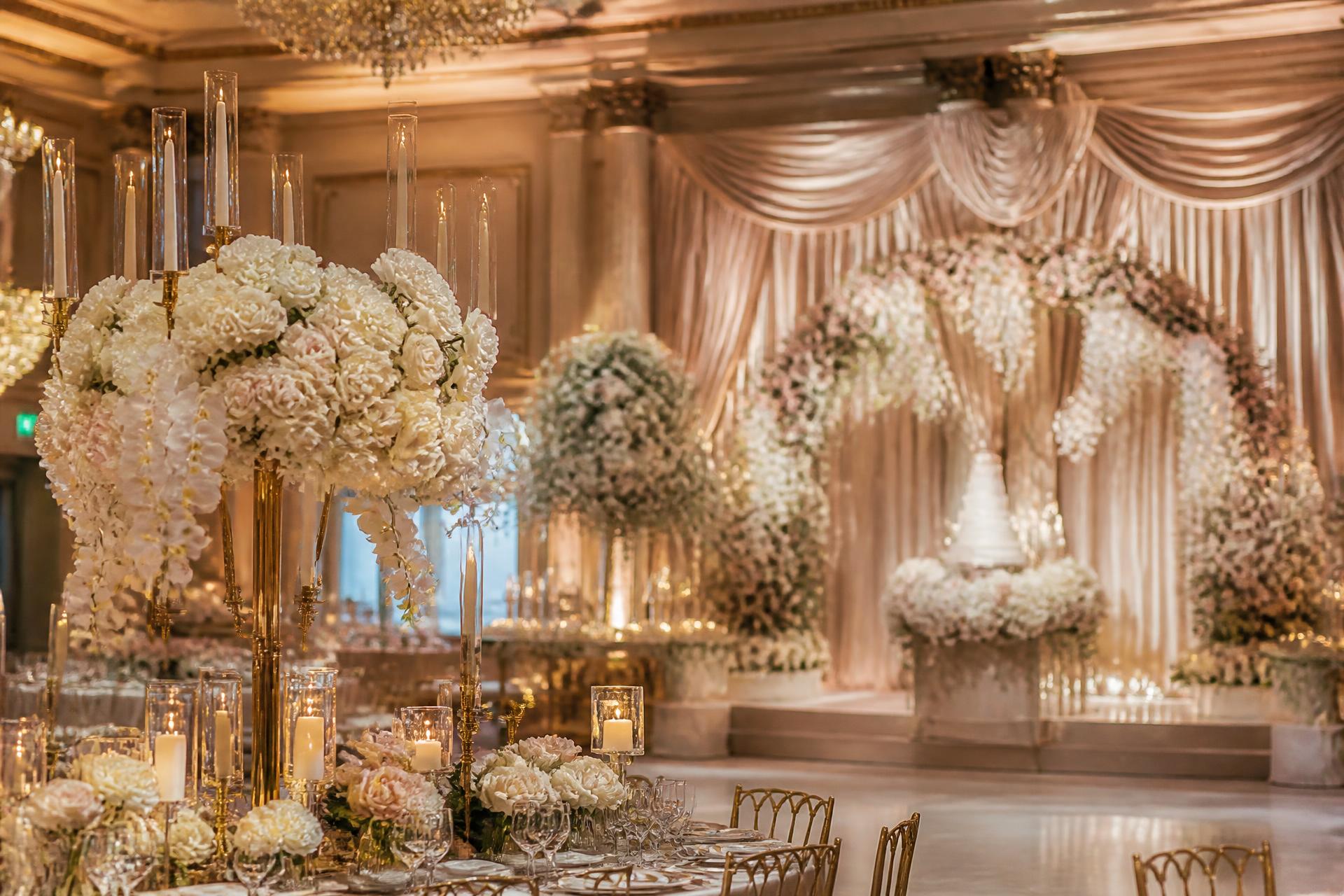 Luxury ballroom decorated with white roses, gold candelabras and soft drapery